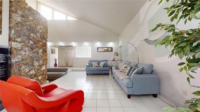 living room with light tile patterned flooring and high vaulted ceiling