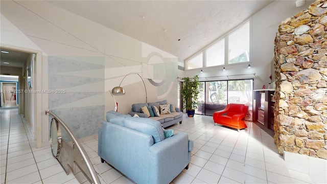 living room featuring light tile patterned floors and high vaulted ceiling