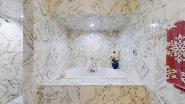 bathroom featuring tiled tub