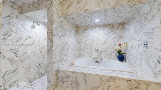 bathroom with a relaxing tiled tub