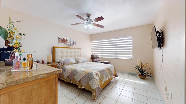 tiled bedroom featuring ceiling fan