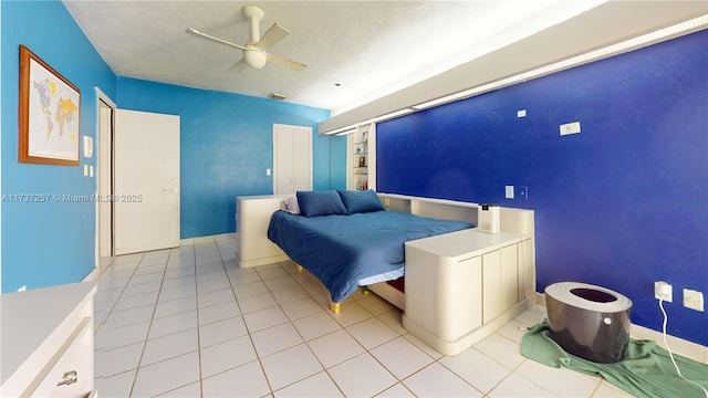 tiled bedroom featuring ceiling fan