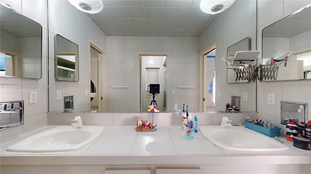 bathroom with tile walls and vanity