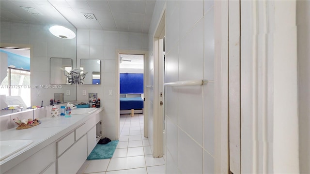 bathroom with tile patterned floors, tile walls, and vanity