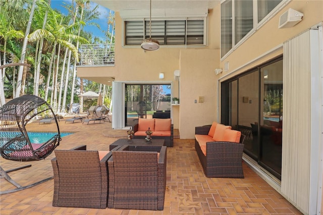 view of patio featuring a pool and an outdoor living space