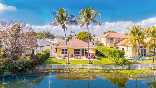 back of house with a patio and a water view