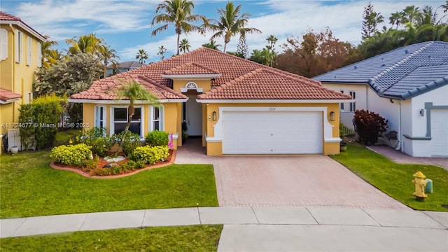 mediterranean / spanish-style house featuring a garage and a front lawn