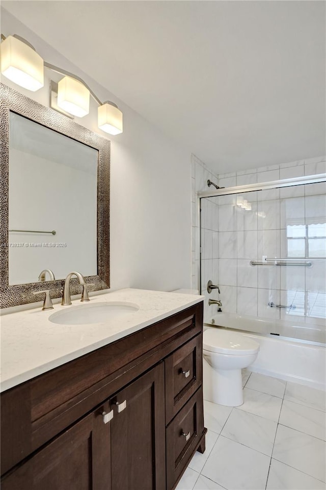 full bathroom with toilet, vanity, and shower / bath combination with glass door