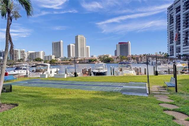 view of property's community featuring a water view and a lawn