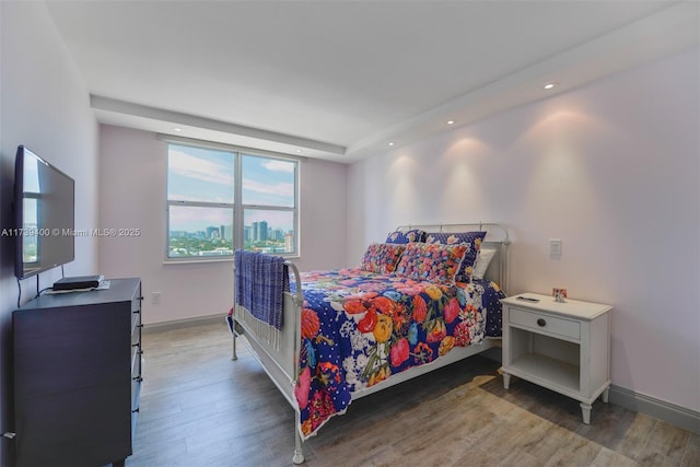 bedroom with dark hardwood / wood-style floors