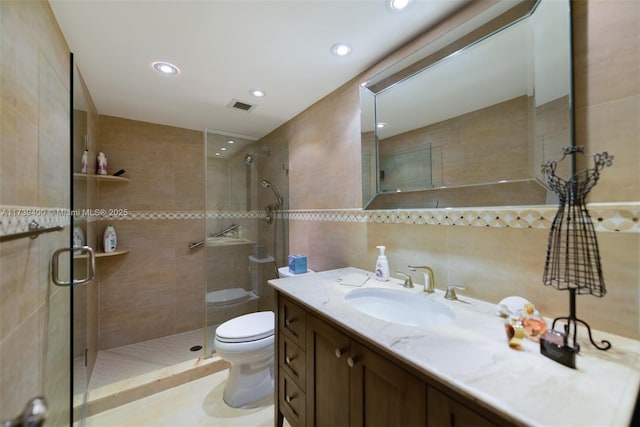 bathroom featuring tile walls, backsplash, vanity, an enclosed shower, and toilet