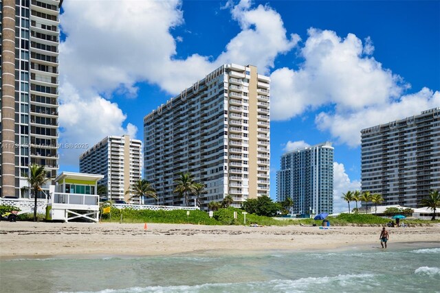 view of building exterior featuring a view of the beach and a water view