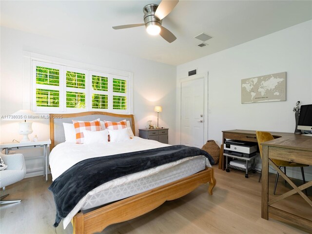 bedroom with light hardwood / wood-style flooring and ceiling fan