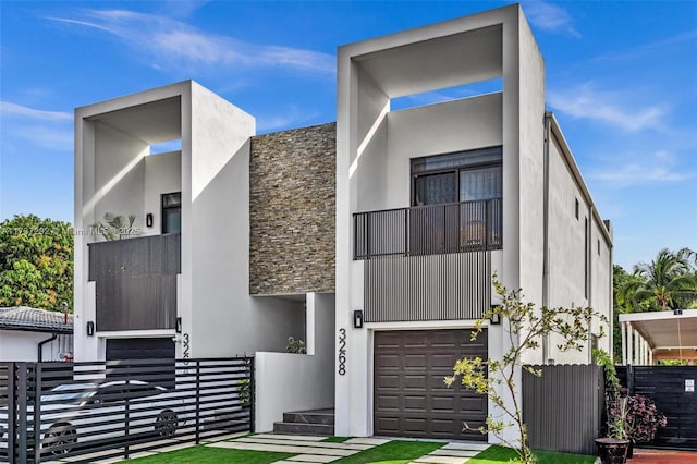 contemporary home featuring a garage and a balcony