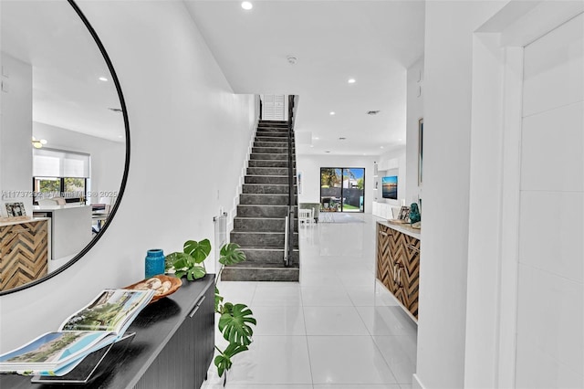 stairs with tile patterned flooring and a wealth of natural light