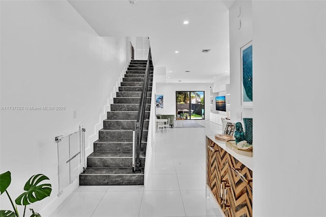 stairs featuring tile patterned floors