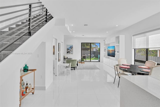 hall featuring light tile patterned floors