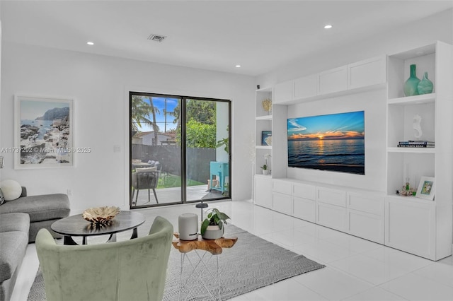 living room featuring light tile patterned floors and built in shelves