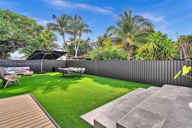 view of yard with outdoor lounge area and a patio