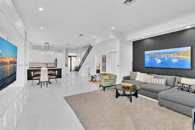 tiled living room with an inviting chandelier