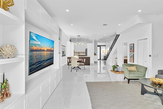 living room featuring light tile patterned floors and a chandelier