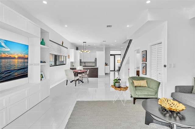 living room featuring light tile patterned floors and an inviting chandelier