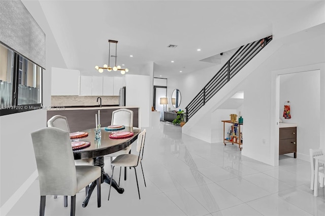 dining space featuring sink and a chandelier