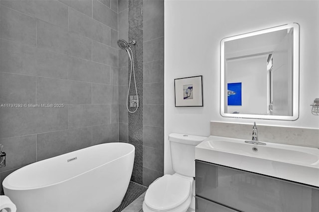 bathroom with vanity, a tub to relax in, tile walls, and toilet