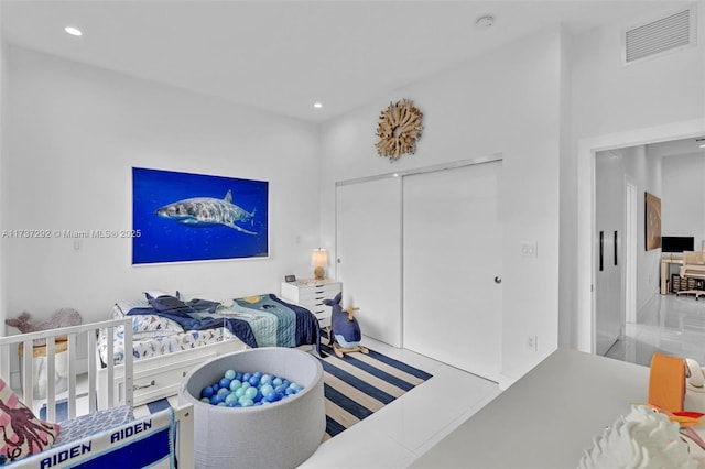 tiled bedroom with a closet