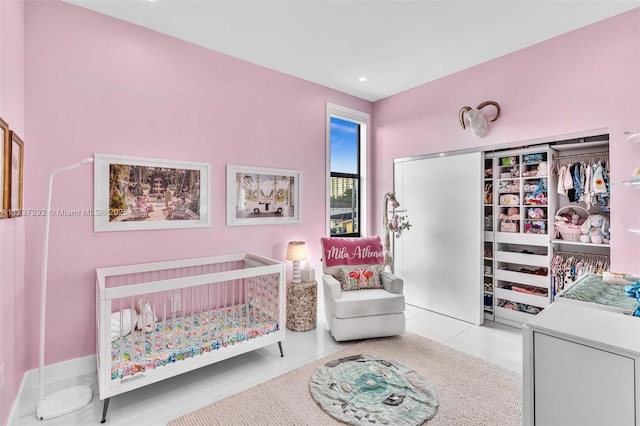 tiled bedroom with a crib