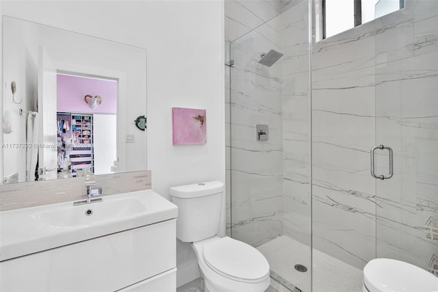 bathroom featuring vanity, tasteful backsplash, a shower with door, and toilet