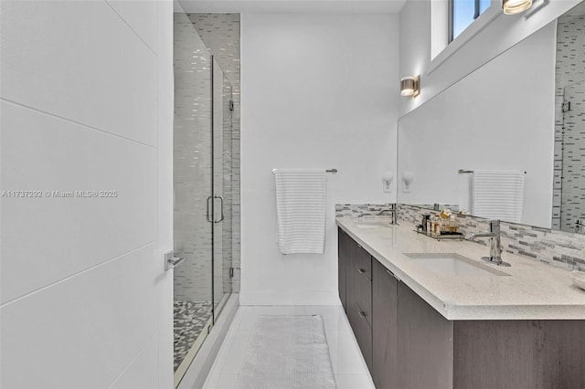 bathroom featuring vanity, backsplash, tile patterned flooring, and a shower with door