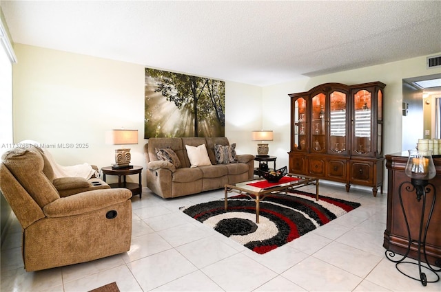 living room with light tile patterned flooring and a textured ceiling