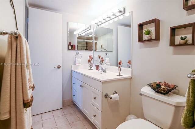 bathroom with vanity, tile patterned floors, and toilet