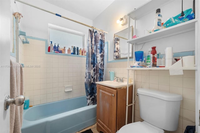 full bathroom featuring vanity, tile walls, shower / bathtub combination with curtain, and toilet