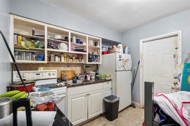 kitchen featuring white cabinetry, sink, white appliances, and light tile patterned floors