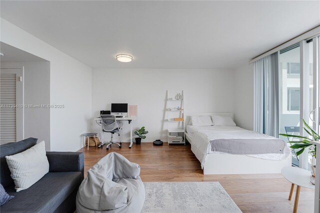 bedroom with hardwood / wood-style floors