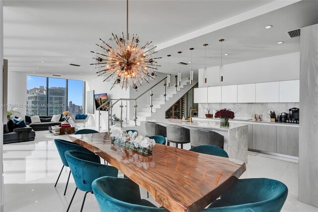 tiled dining space with an inviting chandelier and floor to ceiling windows