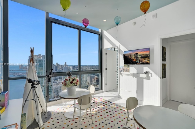 dining room featuring light tile patterned flooring and floor to ceiling windows