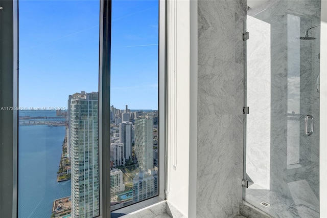 bathroom with walk in shower and a water view