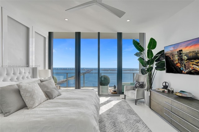 bedroom with expansive windows and ceiling fan