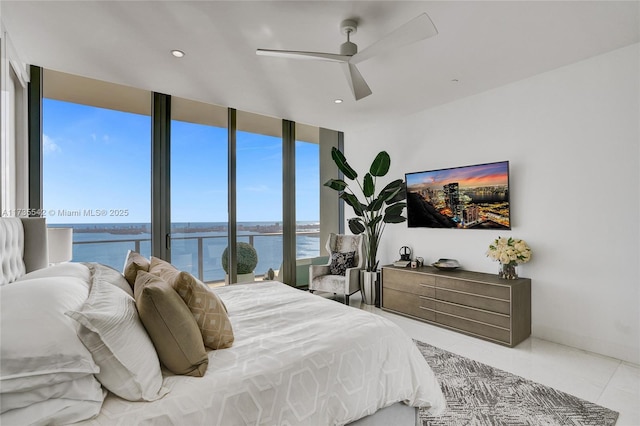 bedroom with expansive windows, a water view, tile patterned floors, and ceiling fan