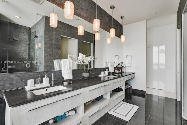 bathroom with vanity, a shower with shower door, and tile patterned flooring