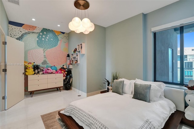 bedroom with light tile patterned floors and an inviting chandelier