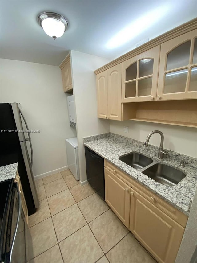 kitchen featuring sink, stainless steel refrigerator, black dishwasher, light stone countertops, and light brown cabinetry