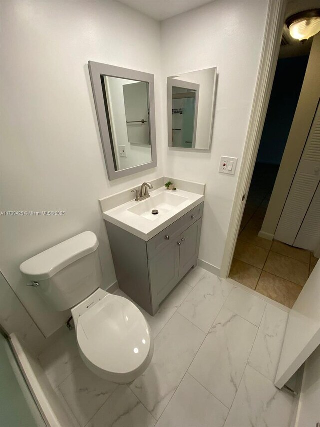 bathroom featuring vanity and toilet