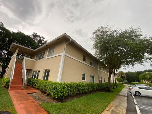 view of side of home featuring a lawn