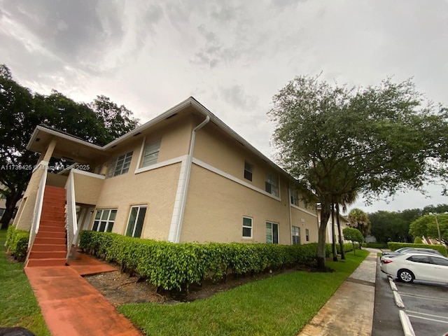 10194 Twin Lakes Dr Unit 14-A, Coral Springs, FL 33071 - view of side of home featuring a lawn