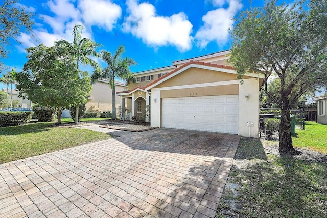 view of front of property with a garage and a front yard