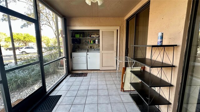 unfurnished sunroom featuring washer and clothes dryer